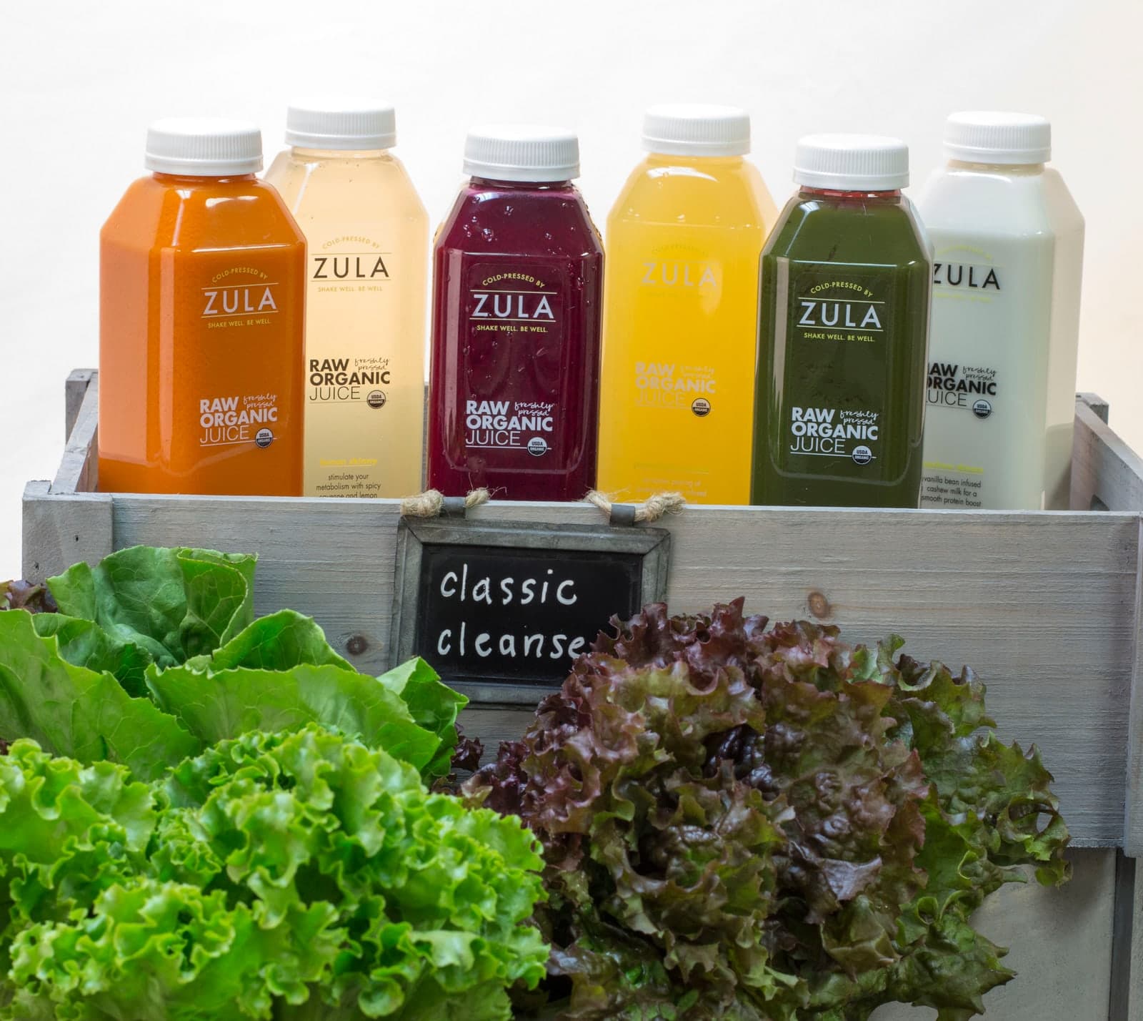 An original Zula cleanse crate with six bottles and greens.
