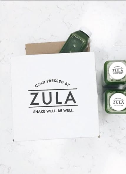 A Zula box beside bottles from the original delivery years.