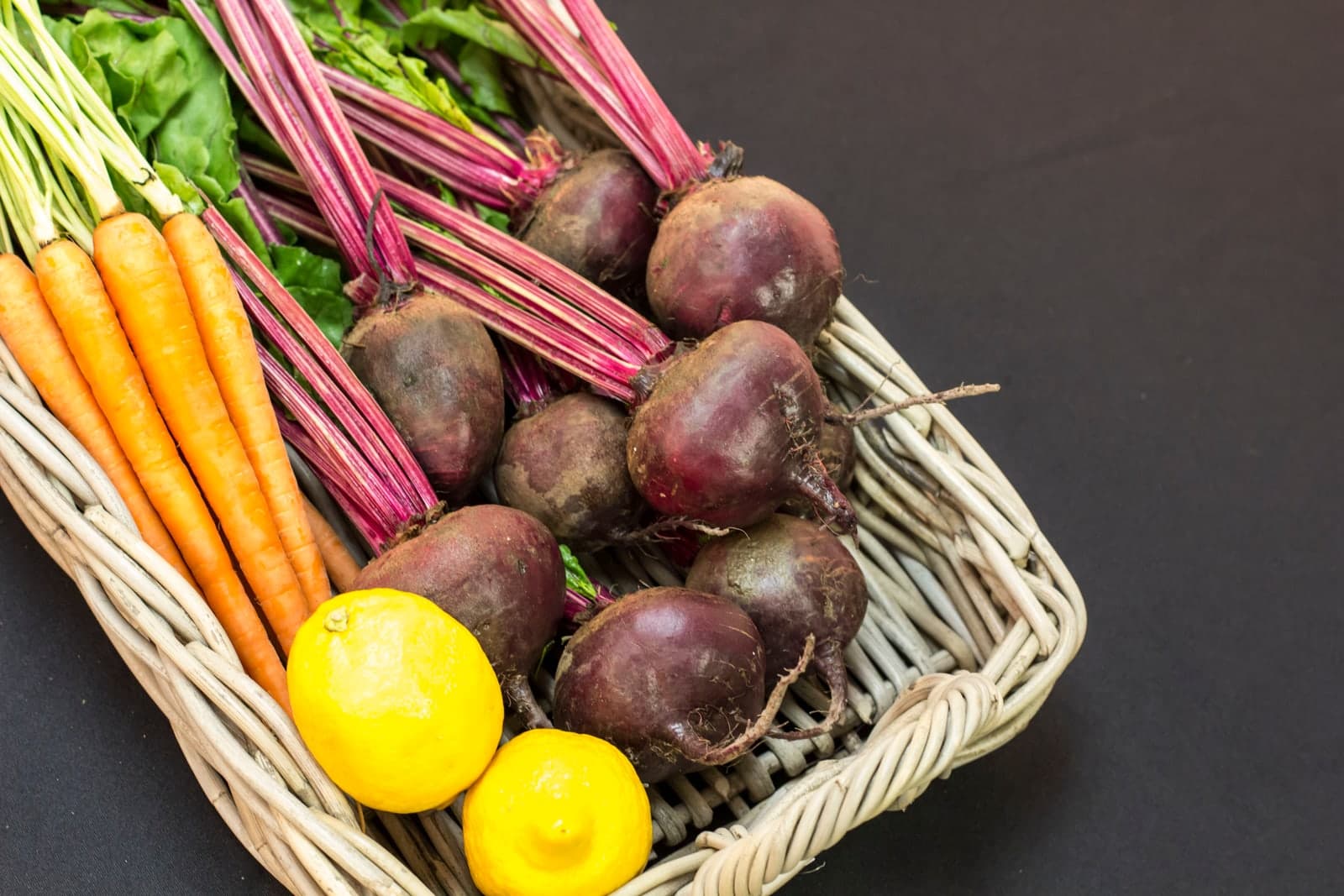 Beets, carrots and lemons in a basket.
